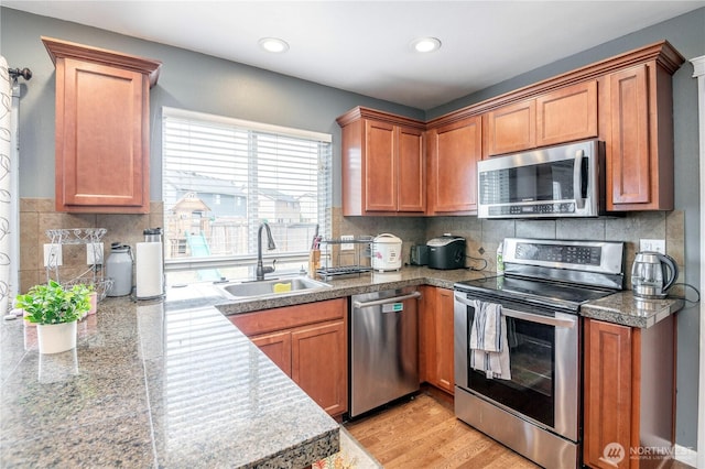 9211 Carys St SE, Yelm, WA 98597 - kitchen with appliances with stainless steel finishes, tile countertops, recessed lighting, brown cabinets, and tasteful backsplash