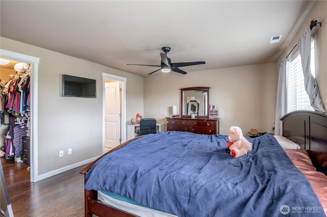 9211 Carys St SE, Yelm, WA 98597 - bedroom with a walk in closet, dark wood-type flooring, and a ceiling fan