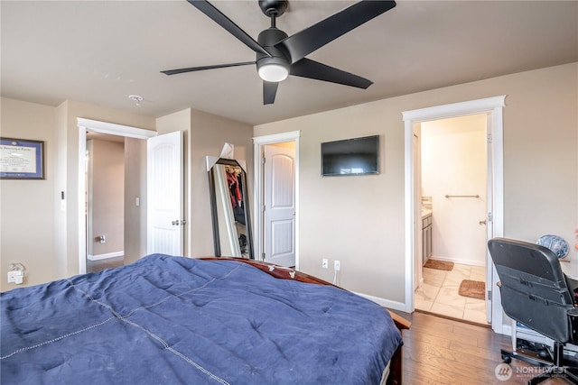 9211 Carys St SE, Yelm, WA 98597 - bedroom featuring ensuite bath, a ceiling fan, and wood finished floors