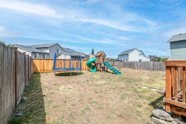 9211 Carys St SE, Yelm, WA 98597 - fenced backyard with a playground, a trampoline, and a residential view