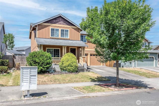 9211 Carys St SE, Yelm, WA 98597 - view of front of home with concrete driveway, an attached garage, board and batten siding, and covered porch