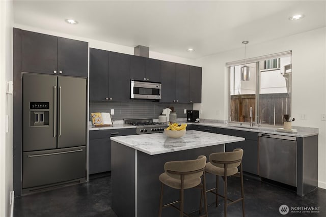 933 16th Avene, Seattle, WA 98122 - kitchen with stainless steel appliances, a breakfast bar, a center island, decorative backsplash, and decorative light fixtures