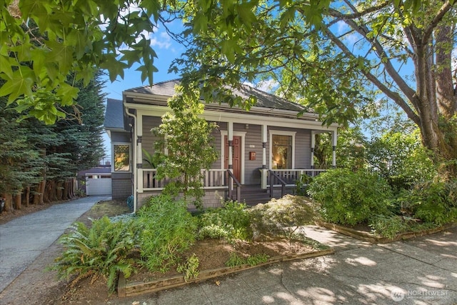 5825 4th Ave NW, Seattle, WA 98107 - view of front of house featuring a porch, an outdoor structure, and a garage
