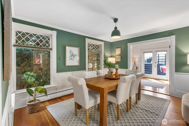 5825 4th Ave NW, Seattle, WA 98107 - dining area featuring a baseboard radiator, wainscoting, french doors, wood finished floors, and ornamental molding