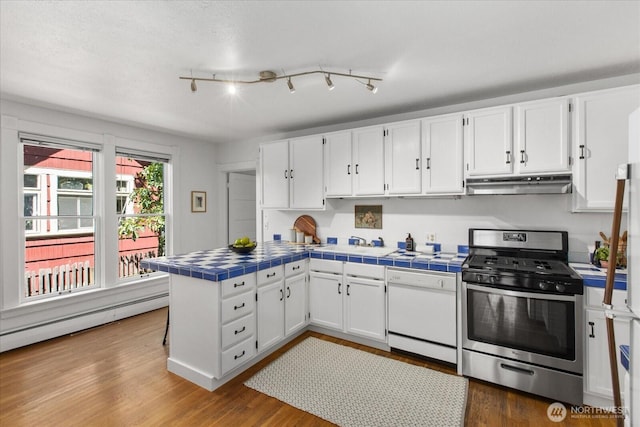 5825 4th Ave NW, Seattle, WA 98107 - kitchen with stainless steel gas stove, under cabinet range hood, tile countertops, dishwasher, and a peninsula