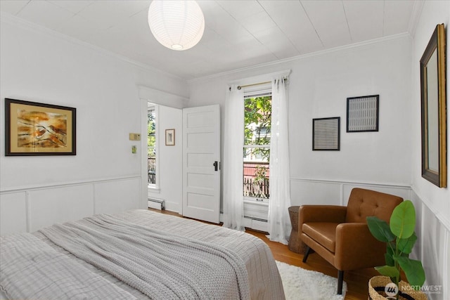 5825 4th Ave NW, Seattle, WA 98107 - bedroom with a baseboard radiator, wood finished floors, ornamental molding, a wainscoted wall, and a decorative wall