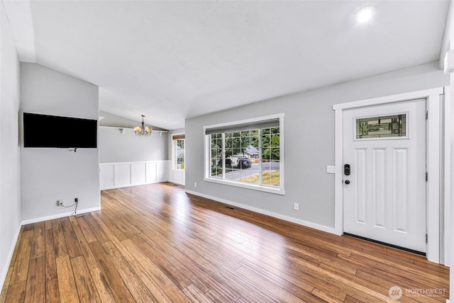 3919 Timothy Ct, Bellingham, WA 98226 - unfurnished living room featuring vaulted ceiling, a chandelier, and wood-type flooring