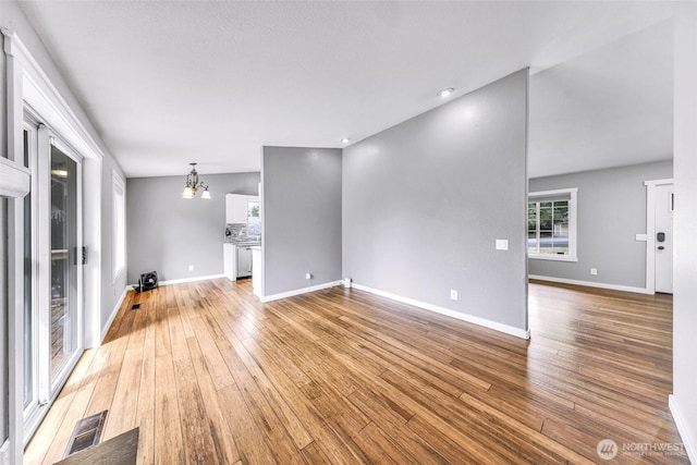 3919 Timothy Ct, Bellingham, WA 98226 - unfurnished living room featuring light wood-style floors and a chandelier