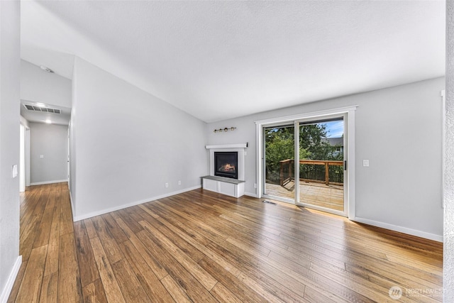 3919 Timothy Ct, Bellingham, WA 98226 - unfurnished living room with wood-type flooring and a lit fireplace