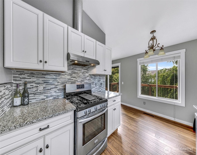 3919 Timothy Ct, Bellingham, WA 98226 - kitchen with stainless steel range with gas cooktop, under cabinet range hood, tasteful backsplash, light wood-style floors, and white cabinets