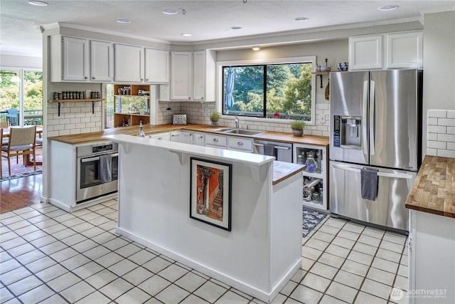 15638 94th Ave SW, Vashon, WA 98070 - kitchen featuring appliances with stainless steel finishes, wood counters, open shelves, white cabinetry, and recessed lighting