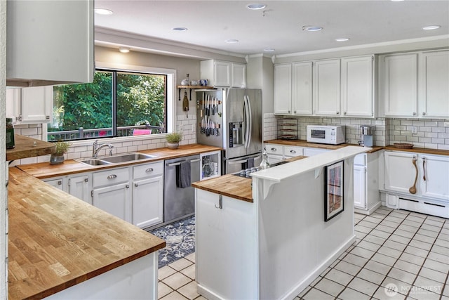 15638 94th Ave SW, Vashon, WA 98070 - kitchen with wood counters, appliances with stainless steel finishes, white cabinetry, open shelves, and recessed lighting