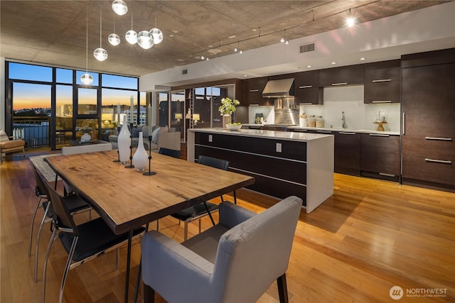 2911 2nd Ave Unit 1120, Seattle, WA 98121 - dining area with light wood-style flooring and expansive windows