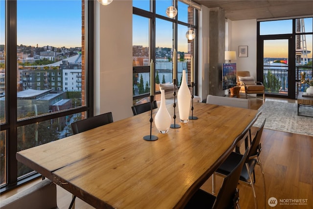 2911 2nd Ave Unit 1120, Seattle, WA 98121 - dining room featuring a view of city, wood finished floors, and floor to ceiling windows