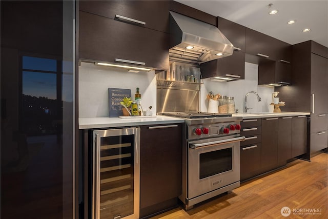 2911 2nd Ave Unit 1120, Seattle, WA 98121 - kitchen with beverage cooler, island exhaust hood, designer range, modern cabinets, and light wood-type flooring