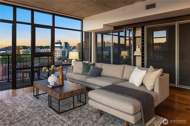2911 2nd Ave Unit 1120, Seattle, WA 98121 - living room featuring wood finished floors, a city view, and floor to ceiling windows