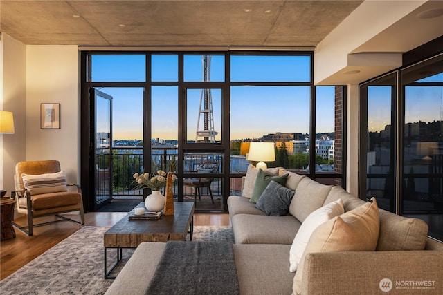 2911 2nd Ave Unit 1120, Seattle, WA 98121 - living room with expansive windows, wood finished floors, a city view, and healthy amount of natural light