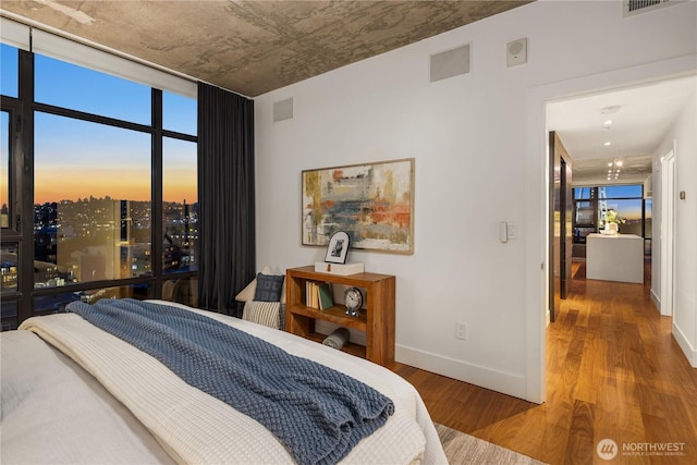 2911 2nd Ave Unit 1120, Seattle, WA 98121 - bedroom featuring wood finished floors and baseboards