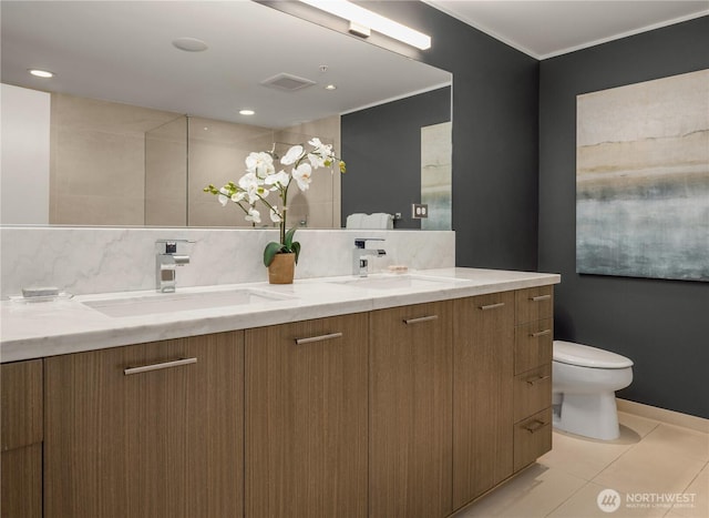 2911 2nd Ave Unit 1120, Seattle, WA 98121 - bathroom with double vanity, tile patterned flooring, decorative backsplash, and crown molding