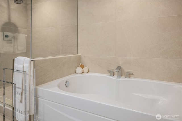 2911 2nd Ave Unit 1120, Seattle, WA 98121 - bathroom featuring a garden tub and tile walls