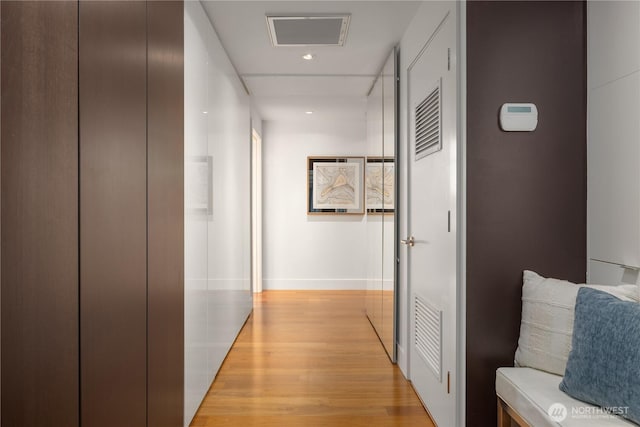 2911 2nd Ave Unit 1120, Seattle, WA 98121 - hall featuring light wood-type flooring, elevator, and recessed lighting