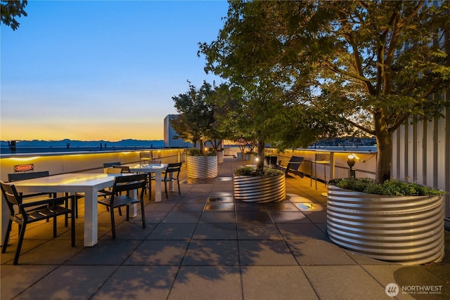 2911 2nd Ave Unit 1120, Seattle, WA 98121 - patio terrace at dusk with outdoor dining area and a patio area