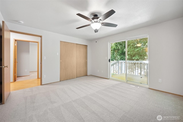 1726 Ann St NE, Olympia, WA 98506 - unfurnished bedroom featuring access to outside, carpet flooring, a closet, and ceiling fan