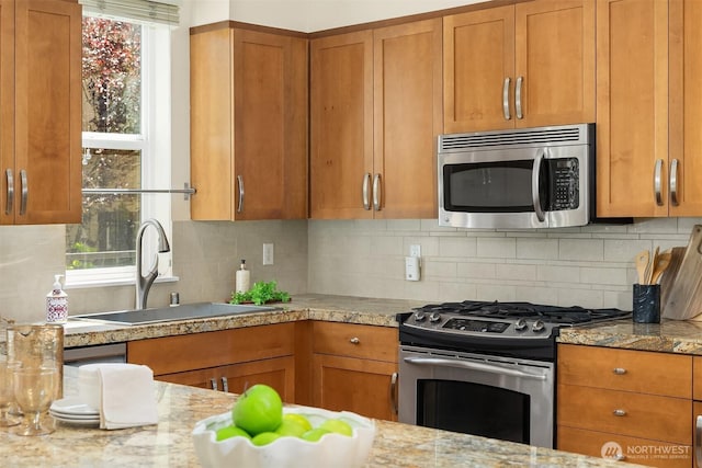 1840 25th Ave NE Unit 210, Issaquah, WA 98029 - kitchen featuring stainless steel appliances, brown cabinets, and backsplash