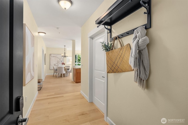 1840 25th Ave NE Unit 210, Issaquah, WA 98029 - hallway with light wood-style flooring and a chandelier
