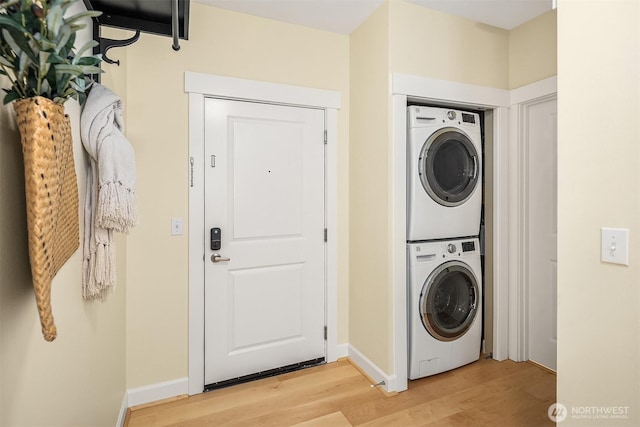 1840 25th Ave NE Unit 210, Issaquah, WA 98029 - laundry area with stacked washer / dryer and light wood-type flooring