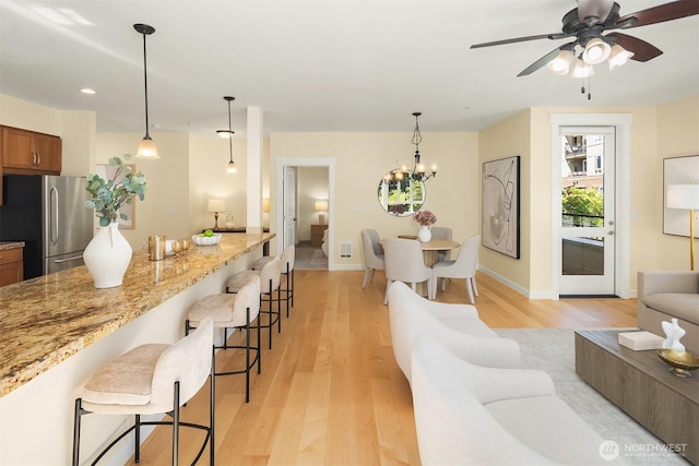 1840 25th Ave NE Unit 210, Issaquah, WA 98029 - living room with light wood-style flooring, a ceiling fan, a chandelier, and recessed lighting
