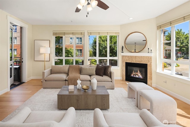 1840 25th Ave NE Unit 210, Issaquah, WA 98029 - living room with light wood-style floors, a ceiling fan, a glass covered fireplace, and recessed lighting