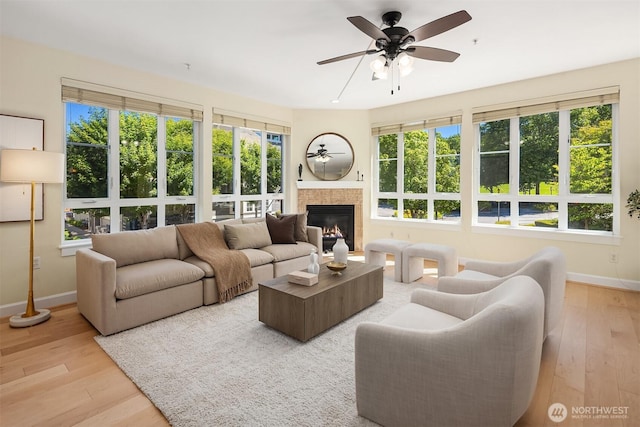1840 25th Ave NE Unit 210, Issaquah, WA 98029 - living room with hardwood / wood-style flooring, a ceiling fan, and a tiled fireplace