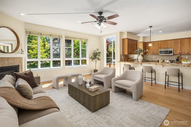 1840 25th Ave NE Unit 210, Issaquah, WA 98029 - living room with light wood-type flooring, recessed lighting, a ceiling fan, and a tile fireplace