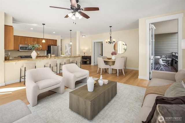 1840 25th Ave NE Unit 210, Issaquah, WA 98029 - living room with light wood finished floors, ceiling fan, recessed lighting, and a chandelier