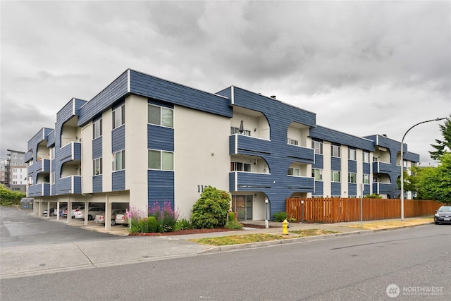 1100AVE NE Harrington Ave NE Unit 211, Renton, WA 98056 - view of building exterior featuring covered parking