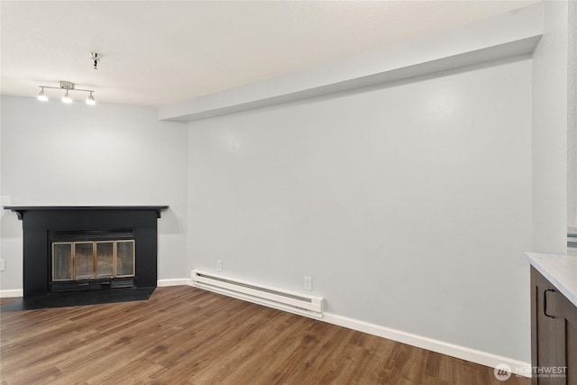1100AVE NE Harrington Ave NE Unit 211, Renton, WA 98056 - unfurnished living room with baseboard heating, a fireplace with flush hearth, and wood finished floors