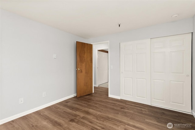 1100AVE NE Harrington Ave NE Unit 211, Renton, WA 98056 - unfurnished bedroom featuring dark wood-style flooring and a closet