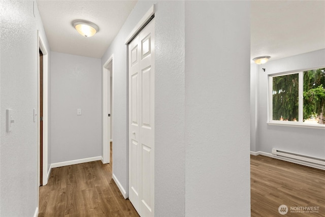 1100AVE NE Harrington Ave NE Unit 211, Renton, WA 98056 - hall featuring wood finished floors and a baseboard heating unit