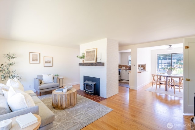 16047 Ashworth Ave N, Shoreline, WA 98133 - living room featuring light wood-style flooring and a wood stove