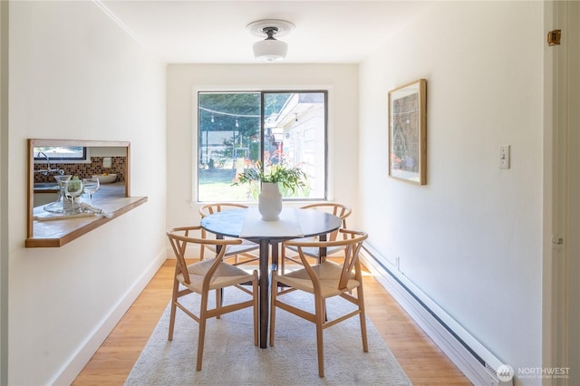 16047 Ashworth Ave N, Shoreline, WA 98133 - dining area with light wood-style floors and a baseboard heating unit