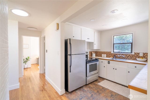 16047 Ashworth Ave N, Shoreline, WA 98133 - kitchen featuring freestanding refrigerator, electric stove, tile countertops, and white cabinetry