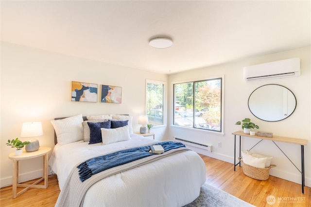 16047 Ashworth Ave N, Shoreline, WA 98133 - bedroom featuring an AC wall unit, a baseboard heating unit, and wood finished floors