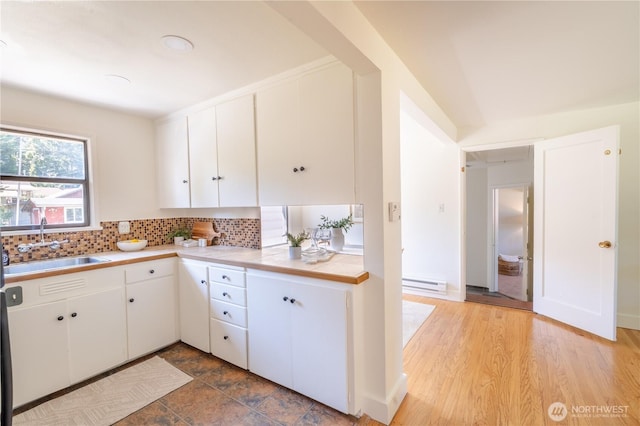 16047 Ashworth Ave N, Shoreline, WA 98133 - kitchen with baseboard heating, light countertops, tasteful backsplash, and white cabinets