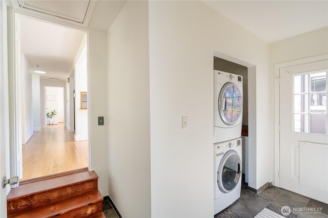16047 Ashworth Ave N, Shoreline, WA 98133 - laundry area featuring stacked washer / drying machine and baseboards