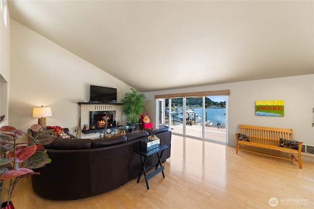 145 Lummi Dr, La Conner, WA 98257 - living room featuring light wood finished floors, a fireplace, and vaulted ceiling