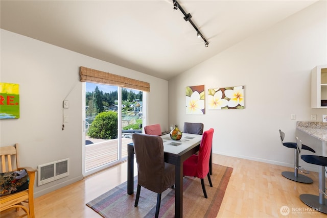145 Lummi Dr, La Conner, WA 98257 - dining space with rail lighting, vaulted ceiling, and light wood-type flooring