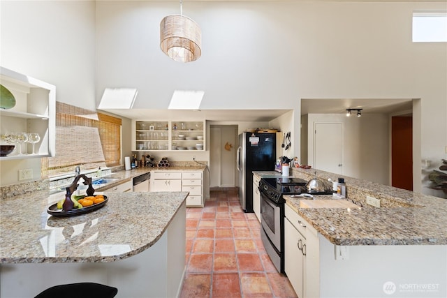 145 Lummi Dr, La Conner, WA 98257 - kitchen with open shelves, stainless steel appliances, a high ceiling, and a peninsula