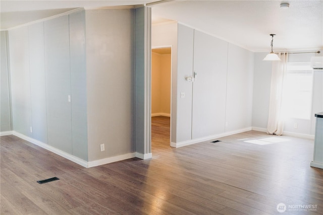 8805 226th Street Ct E Unit 32, Graham, WA 98338 - unfurnished room with wood finished floors, crown molding, a smoke detector, and a wall unit AC