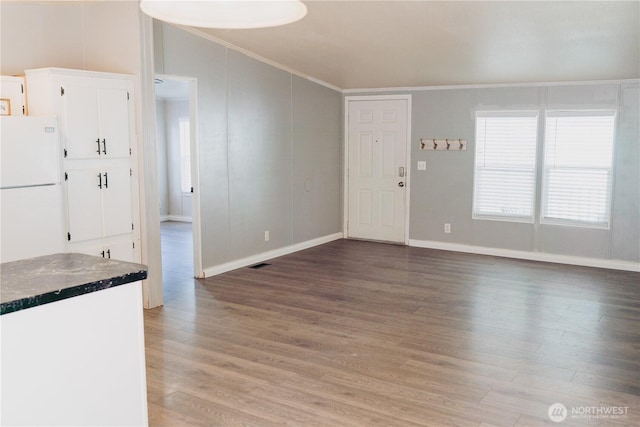 8805 226th Street Ct E Unit 32, Graham, WA 98338 - unfurnished living room with lofted ceiling, light wood-style flooring, healthy amount of natural light, and crown molding